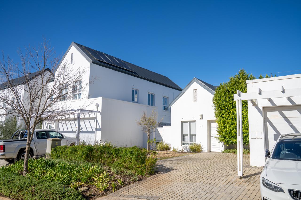 Completed estate homes along a paved driveway, Koelenbosch