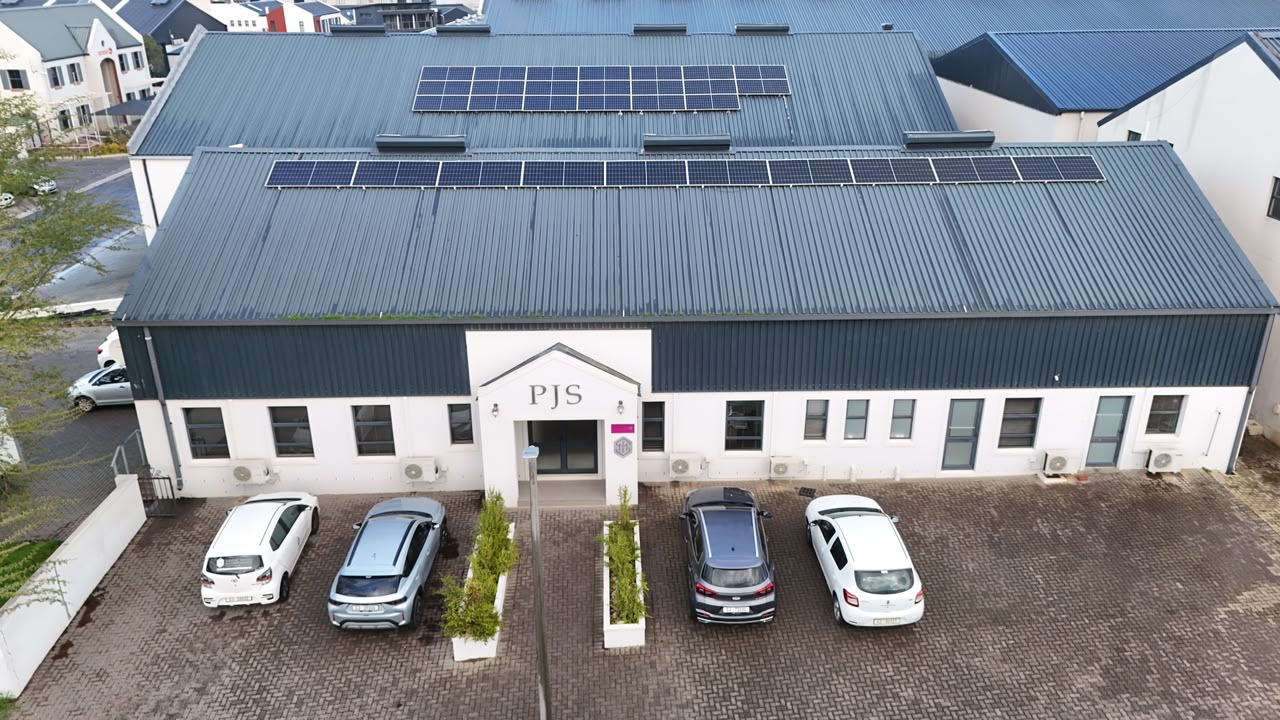 PJS industrial building with rooftop solar panels and paved parking, Paarl