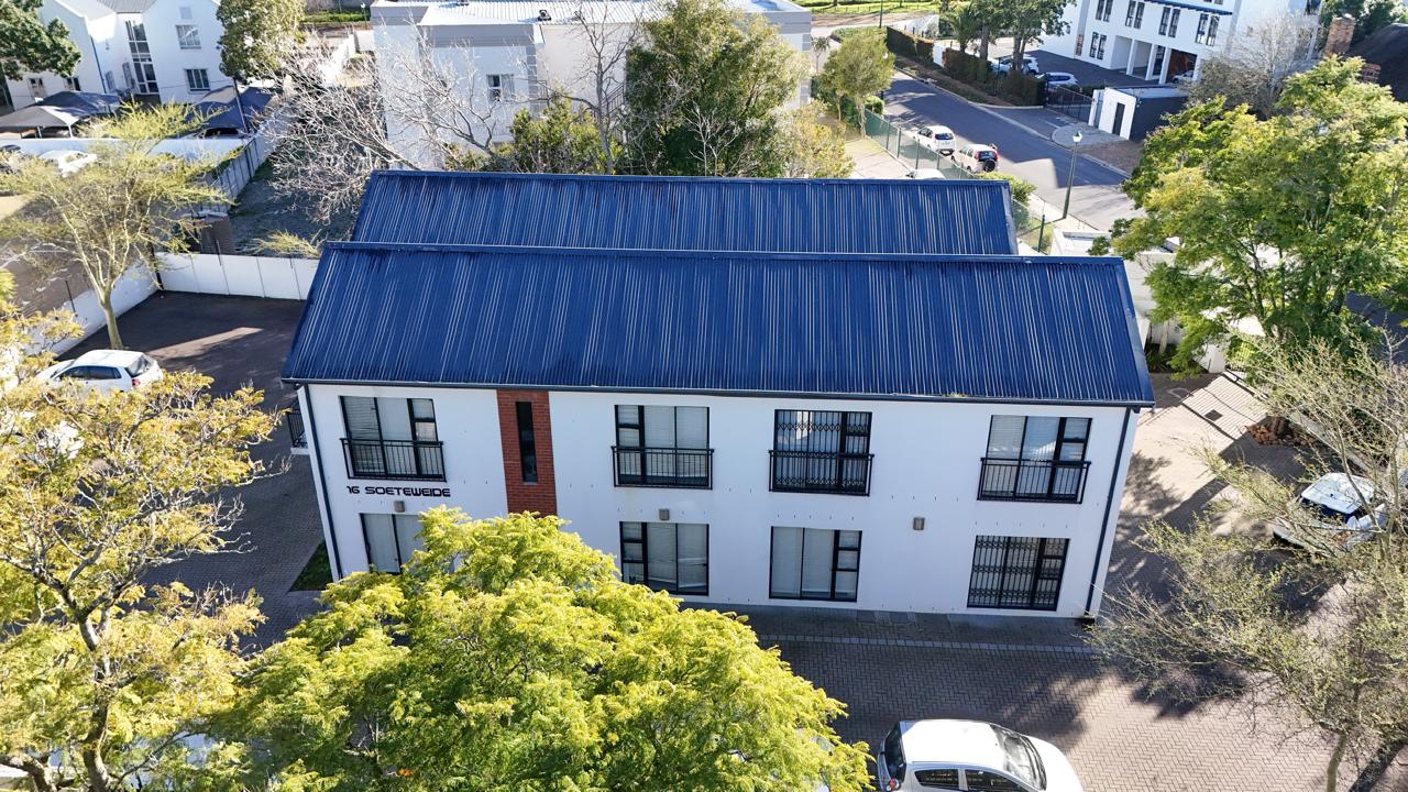 Completed double-storey hostel building with a blue metal roof, Stellenbosch