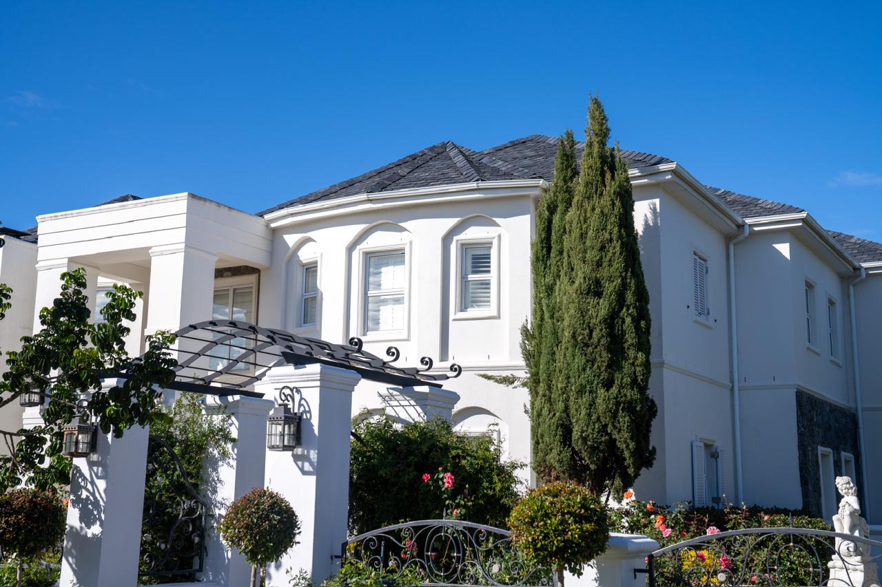 Completed classical-style estate home with cypress trees and a rose garden, Val de Vie
