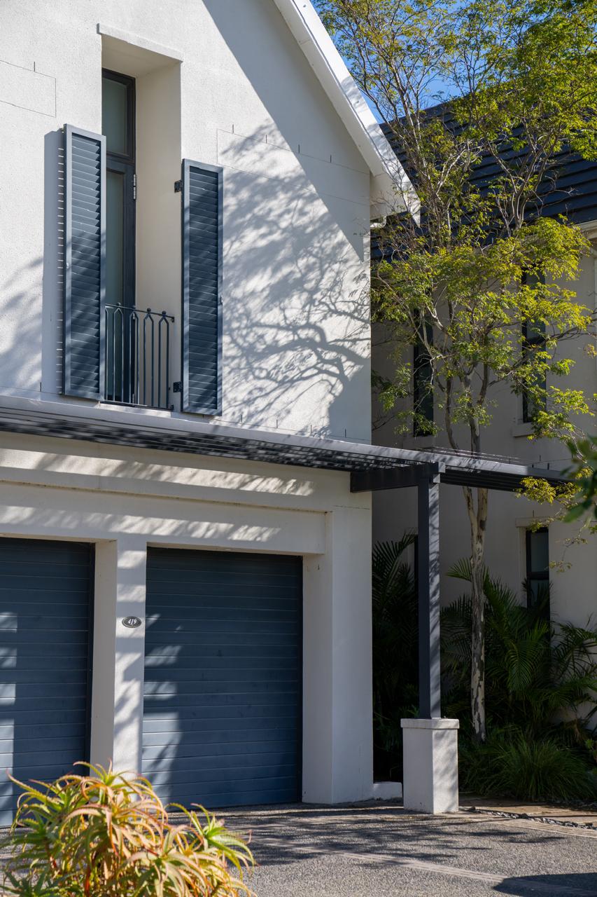 Completed home with grey shutters and a pergola-covered garage, Val de Vie