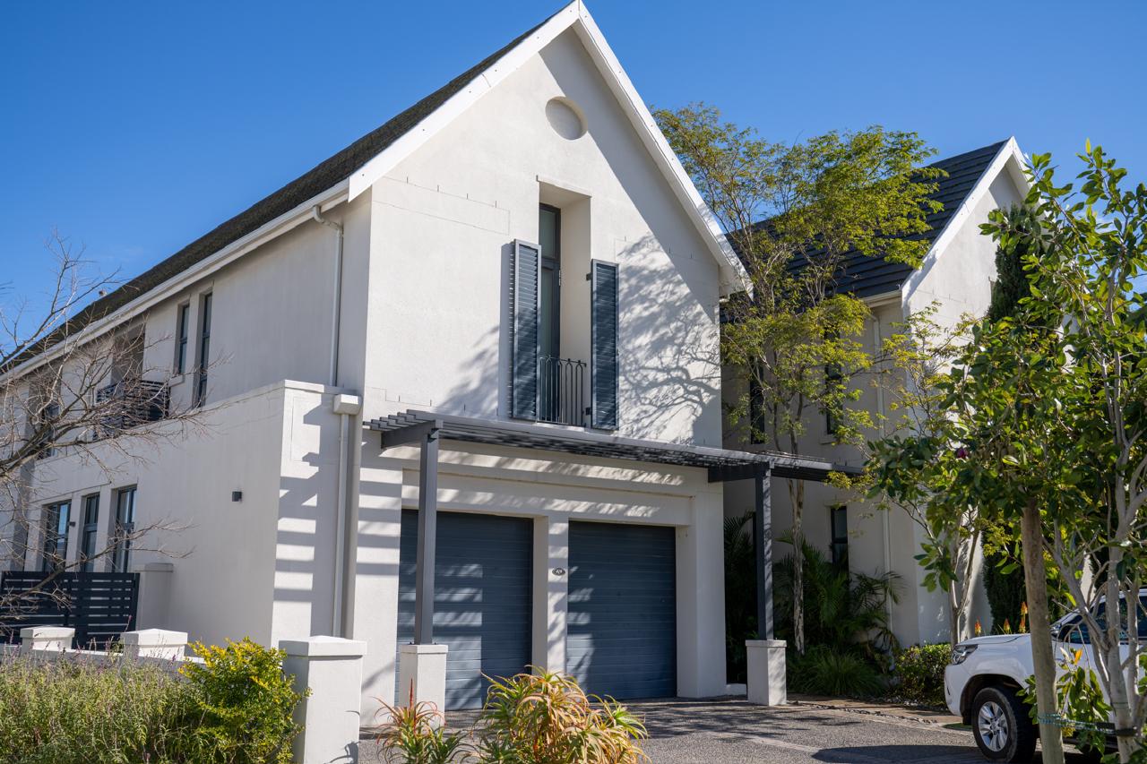 Completed gabled home with a pergola-covered garage, Val de Vie